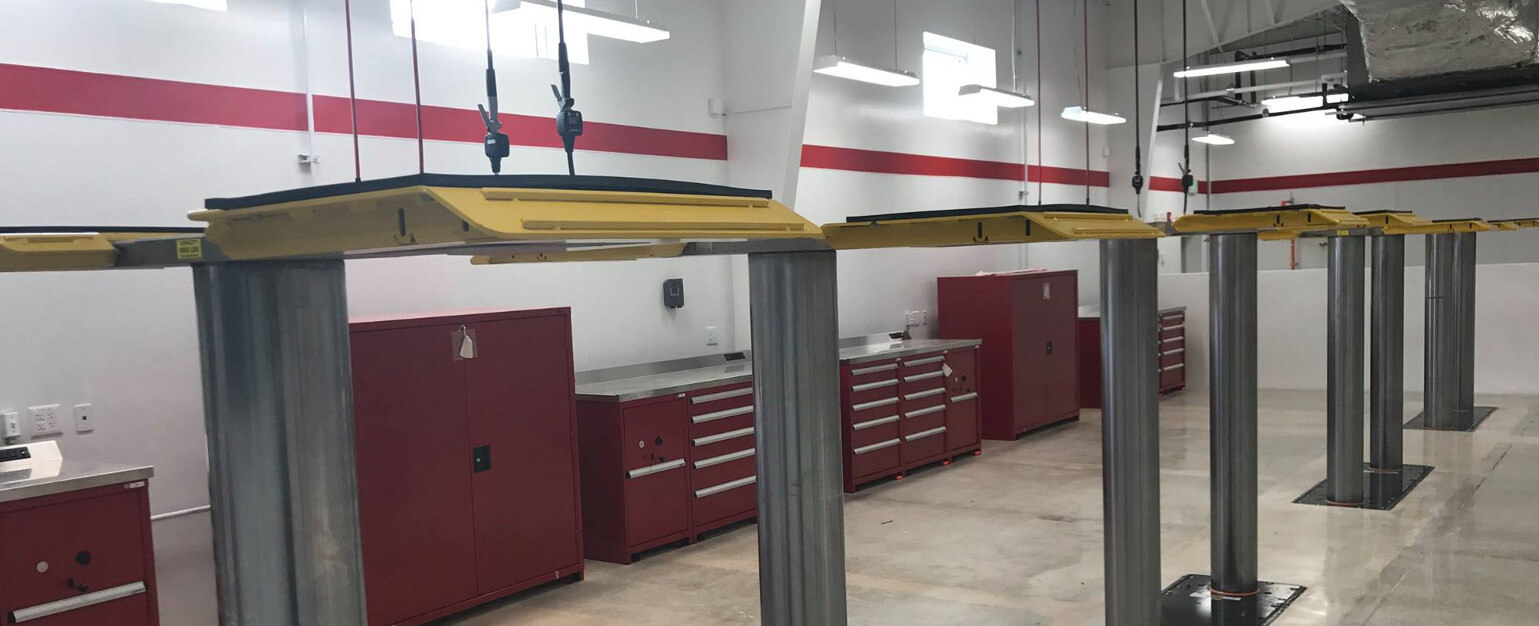 Auto mechanic shop equipment featuring installed vehicle lifts side by side